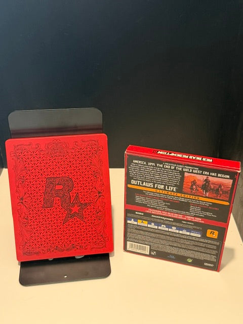 Red Dead Redemption II Ultimate Edition PS4 back of outer box and SteelBook showing Rockstar embossed crest and edge/corner wear on box