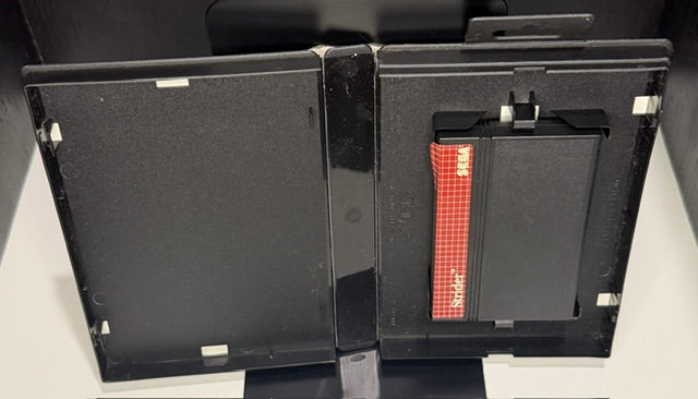 Strider Sega Master System open case showing SMS cartridge with red label and empty manual slot