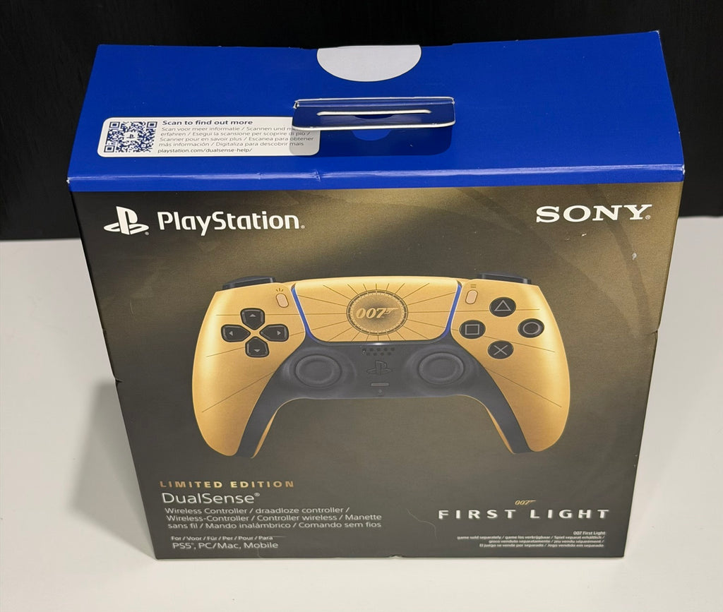 DualSense Limited Edition 007 First Light PS5 controller box front showing gold and black controller with 007 gun barrel logo on touchpad and radiating line faceplate detail