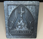 Dark Souls III SteelBook Edition PS4 front showing embossed bonfire and sword motif with Dark Souls III title relief on metal case