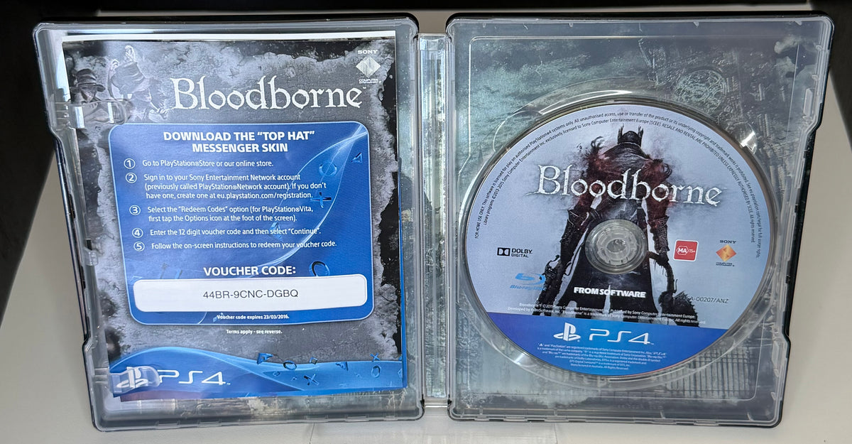 Bloodborne SteelBook Edition PS4 open case showing Top Hat Messenger Skin DLC voucher card on left with expired voucher code and ANZ Blu-ray disc on right