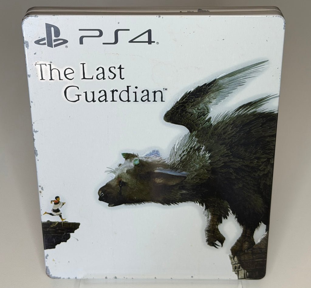 The Last Guardian SteelBook Edition PS4 front showing the Boy running on cliff edge with Trico the feathered creature looming on white-ground metal case with visible surface wear