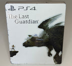 The Last Guardian SteelBook Edition PS4 front showing the Boy running on cliff edge with Trico the feathered creature looming on white-ground metal case with visible surface wear