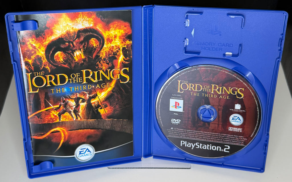 Lord of the Rings The Third Age PS2 open case showing manual with Balrog artwork on left panel and PAL DVD-ROM EA Games disc SLEJ-32601 in right tray