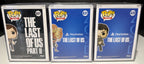 Boxed Ellie 601 Clicker 631 and Joel 620 Funko Pops in hard protective cases, front