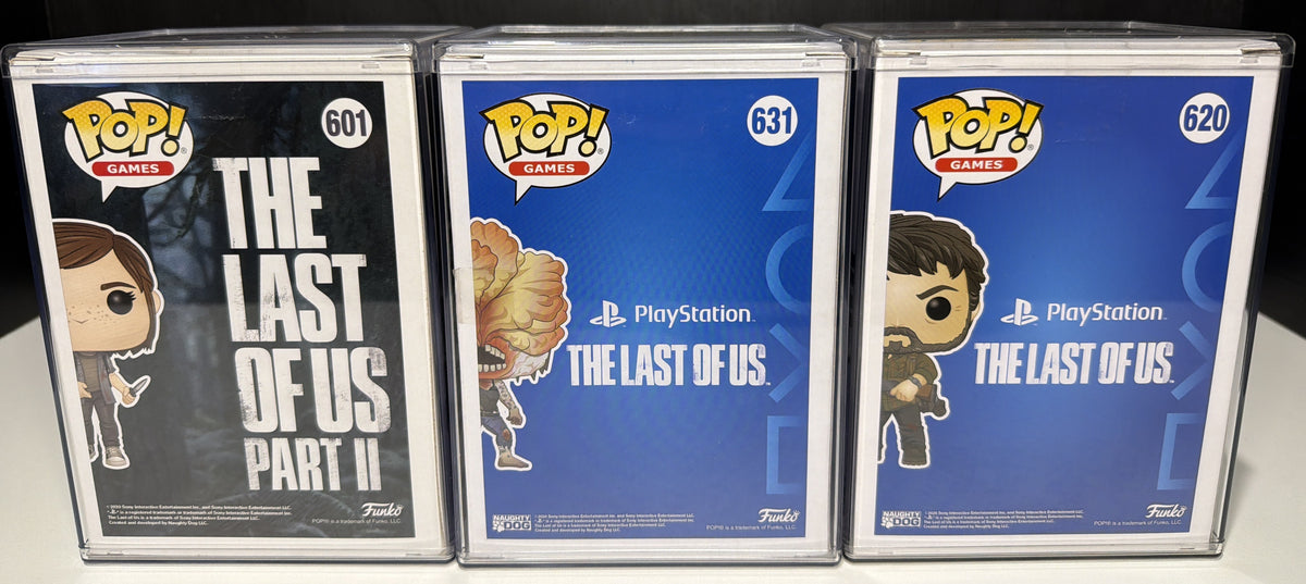 Boxed Ellie 601 Clicker 631 and Joel 620 Funko Pops in hard protective cases, front